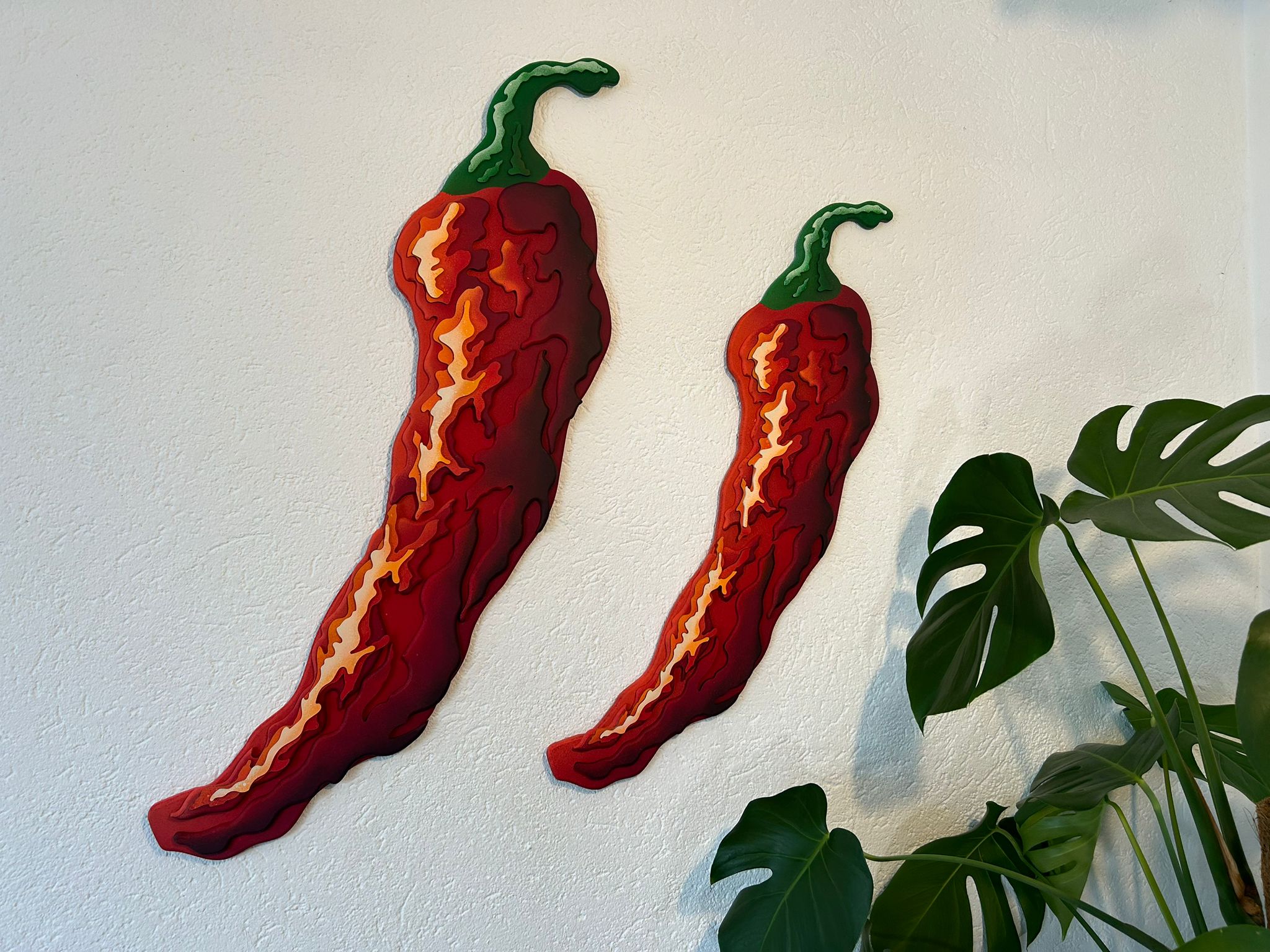 Red peppers installed on a wall